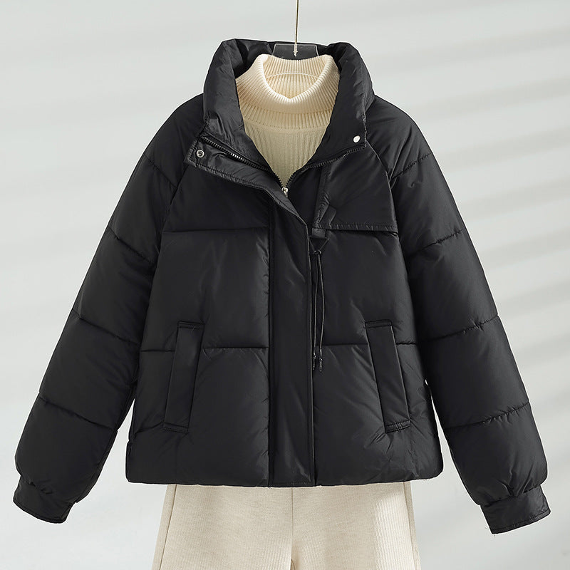 Women's short padded jacket with a boxy fit, stand-up collar, and drawstring.