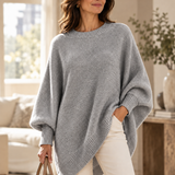 Gray oversized batwing sweater with round neck, ribbed trim, and asymmetric hem