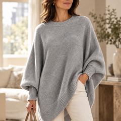 Gray oversized batwing sweater with round neck, ribbed trim, and asymmetric hem