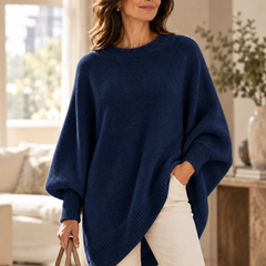 Navy oversized batwing sweater with round neck, ribbed trim, and asymmetric hem