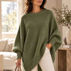 Olive green oversized batwing sweater with round neck, ribbed trim, and asymmetric hem