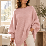 Pink oversized batwing sweater with round neck, ribbed trim, and asymmetric hem