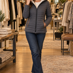 Woman wearing the charcoal gray sherpa-lined Milana quilted jacket at Jennifer Dallas Boutique